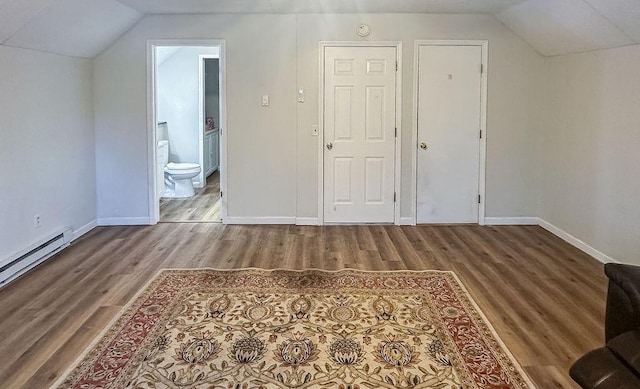 bonus room with lofted ceiling, a baseboard radiator, wood finished floors, and baseboards