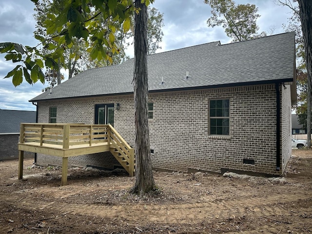 rear view of property with a wooden deck