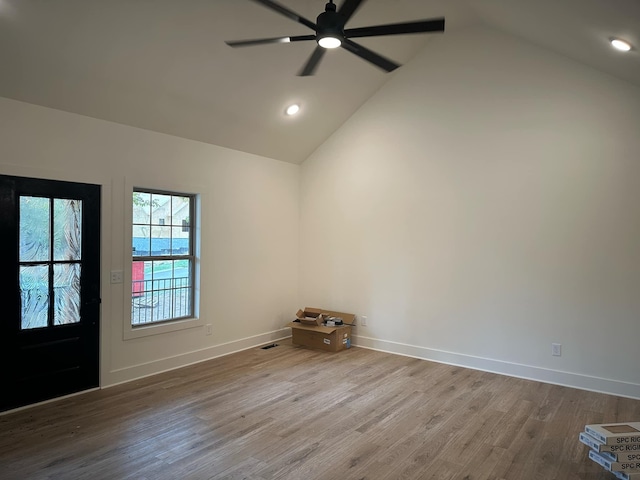 entryway with hardwood / wood-style floors, ceiling fan, and high vaulted ceiling