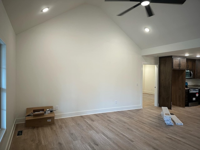 unfurnished living room featuring light wood-type flooring, high vaulted ceiling, and ceiling fan