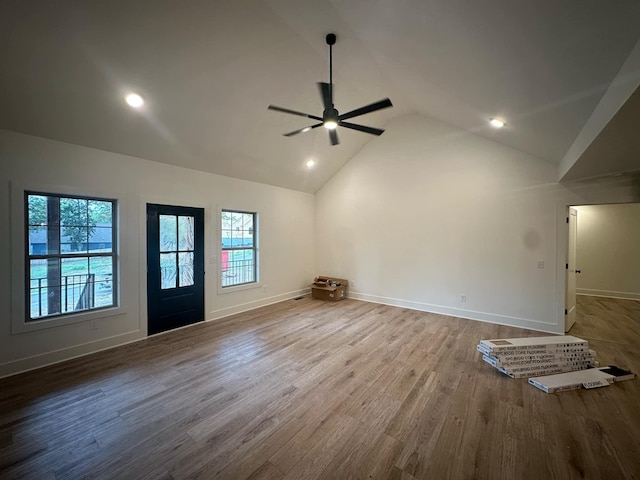 unfurnished living room featuring hardwood / wood-style floors, high vaulted ceiling, and ceiling fan