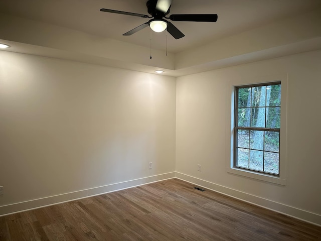 spare room featuring ceiling fan and dark hardwood / wood-style flooring