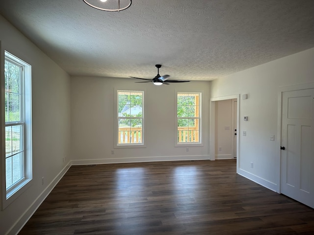 unfurnished room with a textured ceiling, ceiling fan, and dark wood-type flooring