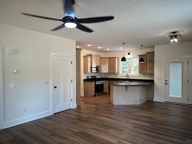 kitchen featuring a kitchen bar, appliances with stainless steel finishes, dark hardwood / wood-style flooring, and hanging light fixtures