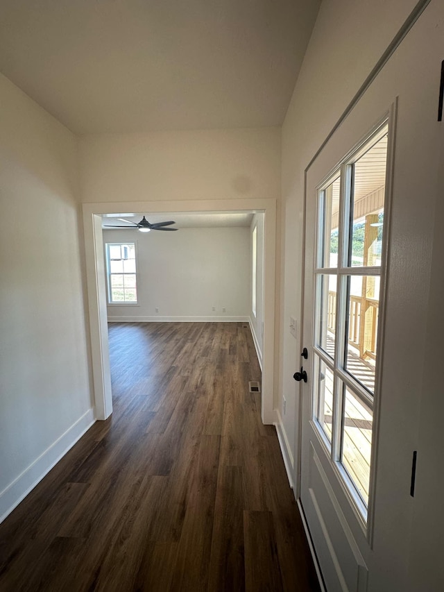 hallway with dark hardwood / wood-style floors