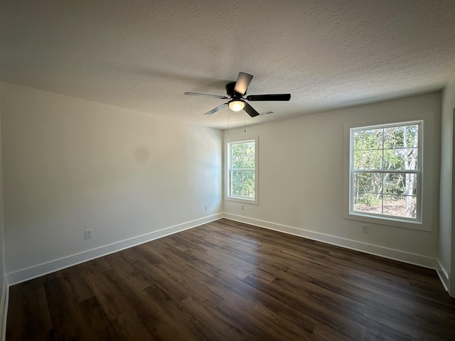 spare room with ceiling fan, dark hardwood / wood-style flooring, and a textured ceiling