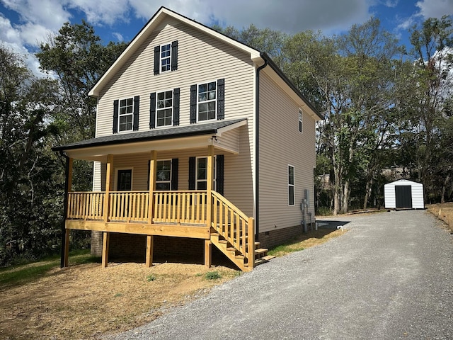 front of property with a storage unit and a porch