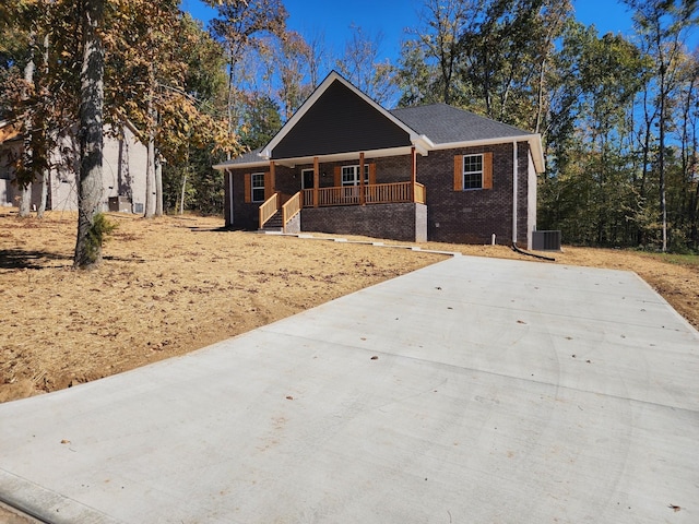 view of front of property featuring covered porch and central air condition unit