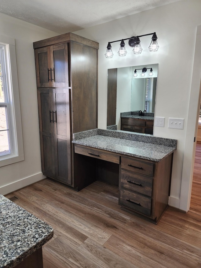 bathroom featuring vanity, wood-type flooring, and a textured ceiling