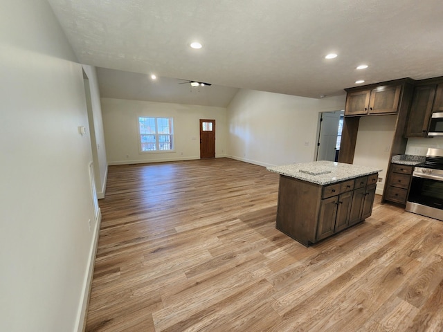 kitchen featuring dark brown cabinets, stainless steel appliances, and light hardwood / wood-style floors