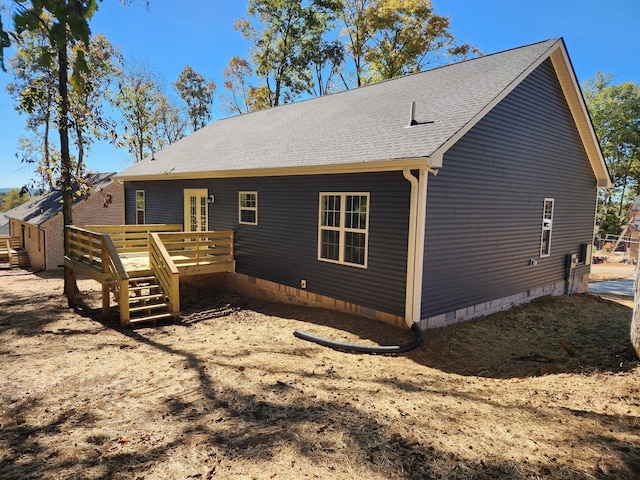 back of property featuring a wooden deck