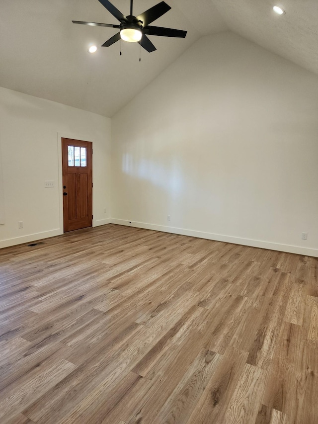 entrance foyer with lofted ceiling, ceiling fan, and light wood-type flooring