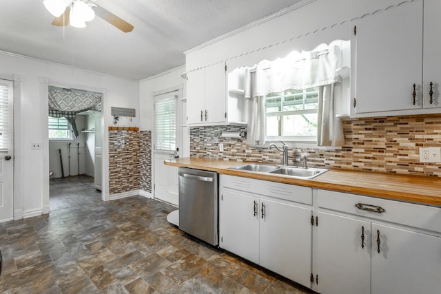 kitchen featuring sink, stainless steel dishwasher, ceiling fan, a textured ceiling, and white cabinetry