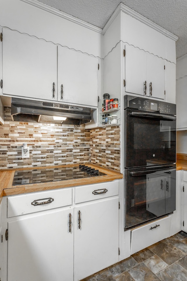 kitchen featuring white cabinets, decorative backsplash, a textured ceiling, and double oven