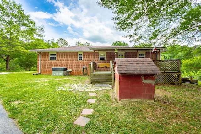 rear view of house with central air condition unit, a wooden deck, and a yard