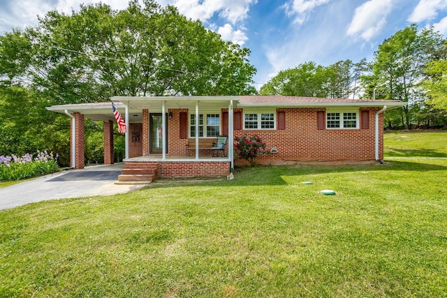 single story home with a carport, a porch, and a front yard