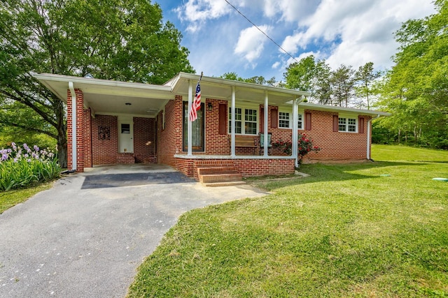 single story home featuring covered porch, a front lawn, and a carport