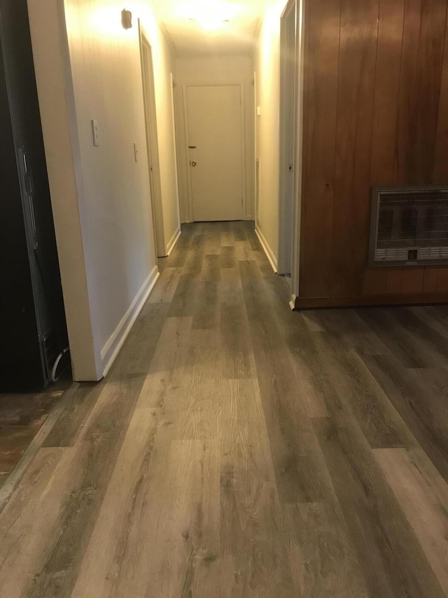 hall with heating unit and dark hardwood / wood-style flooring