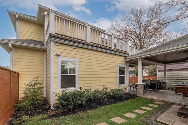 back of house with a balcony and a patio