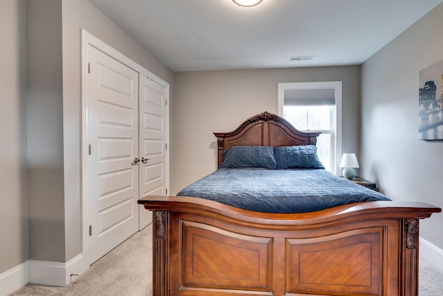 carpeted bedroom featuring a closet