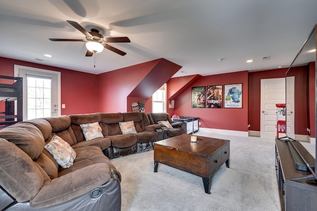 carpeted living room featuring plenty of natural light and ceiling fan