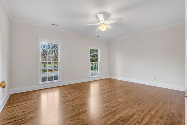 spare room with hardwood / wood-style flooring, crown molding, a healthy amount of sunlight, and ceiling fan