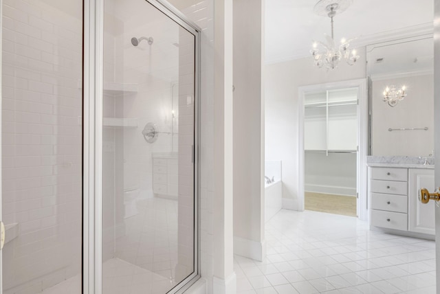 bathroom with an inviting chandelier, vanity, shower with separate bathtub, and crown molding