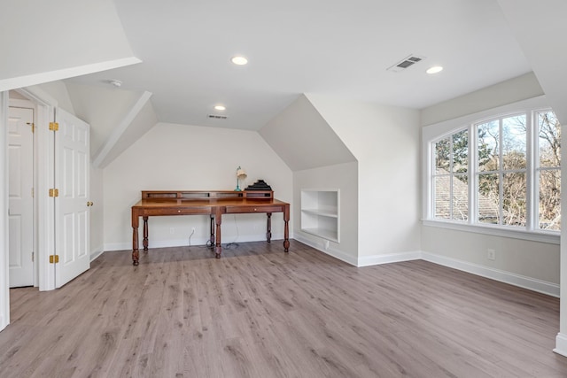 bonus room featuring lofted ceiling, built in features, and light hardwood / wood-style floors