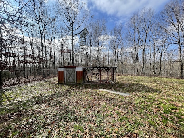 view of outdoor structure with an outbuilding and fence