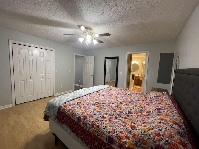 bedroom featuring light wood finished floors, connected bathroom, ceiling fan, a textured ceiling, and baseboards