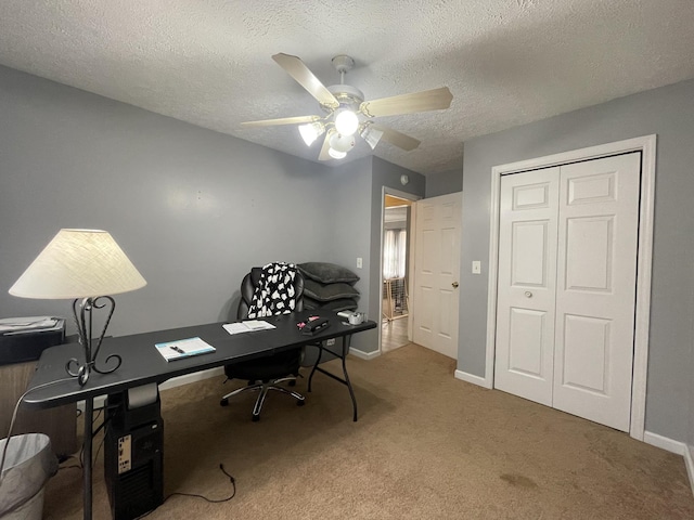 office with ceiling fan, a textured ceiling, baseboards, and carpet flooring