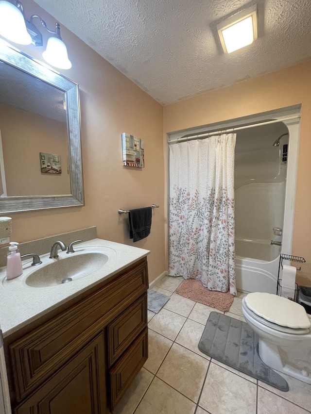 bathroom with toilet, shower / bath combo with shower curtain, vanity, a textured ceiling, and tile patterned flooring