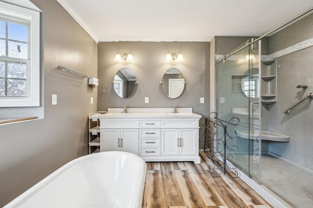 bathroom featuring vanity, wood-type flooring, crown molding, and plus walk in shower