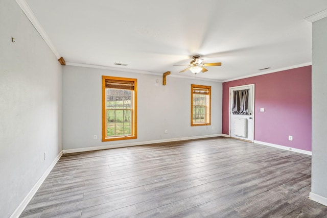 empty room with ceiling fan, ornamental molding, and light wood-type flooring