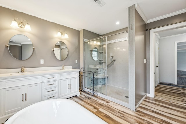 bathroom with separate shower and tub, hardwood / wood-style floors, and ornamental molding