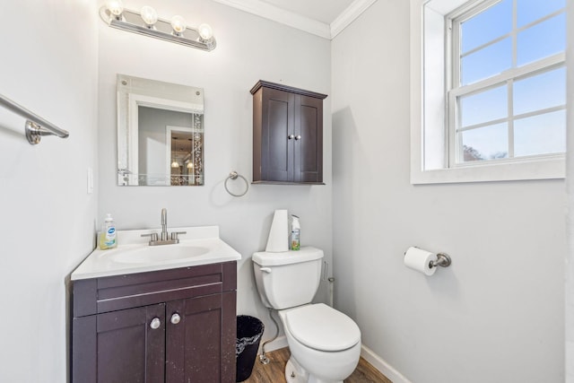 bathroom with hardwood / wood-style flooring, vanity, toilet, and crown molding