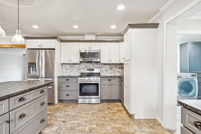 kitchen with gray cabinetry, stainless steel appliances, pendant lighting, washer / dryer, and ornamental molding