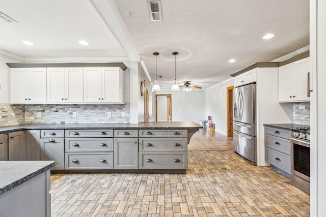 kitchen with gray cabinetry, ceiling fan, decorative light fixtures, and appliances with stainless steel finishes