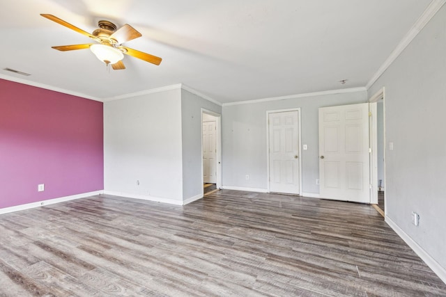 spare room featuring ceiling fan, wood-type flooring, and ornamental molding