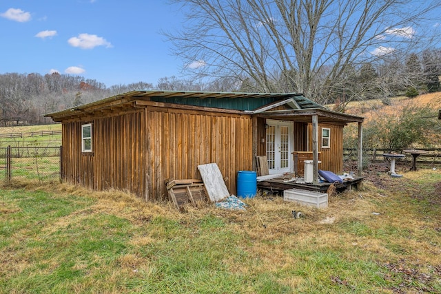 view of outdoor structure with a yard and french doors