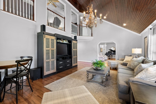 living room with wooden ceiling, high vaulted ceiling, ceiling fan with notable chandelier, crown molding, and wood-type flooring