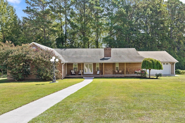 view of front facade featuring covered porch, a garage, and a front yard