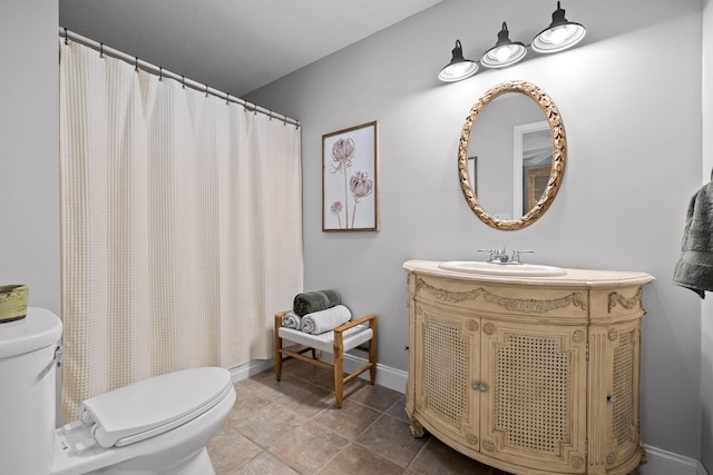 bathroom with curtained shower, vanity, and toilet