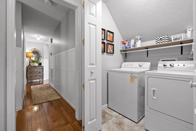 clothes washing area with washer and clothes dryer