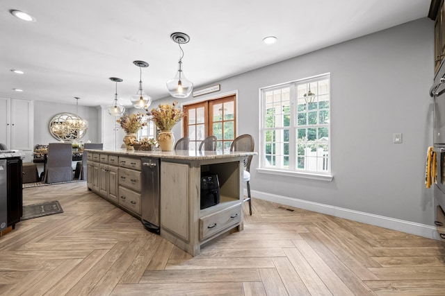 kitchen with a center island, light parquet floors, decorative light fixtures, light stone counters, and a chandelier