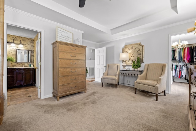 sitting room featuring ornamental molding, a tray ceiling, and light colored carpet