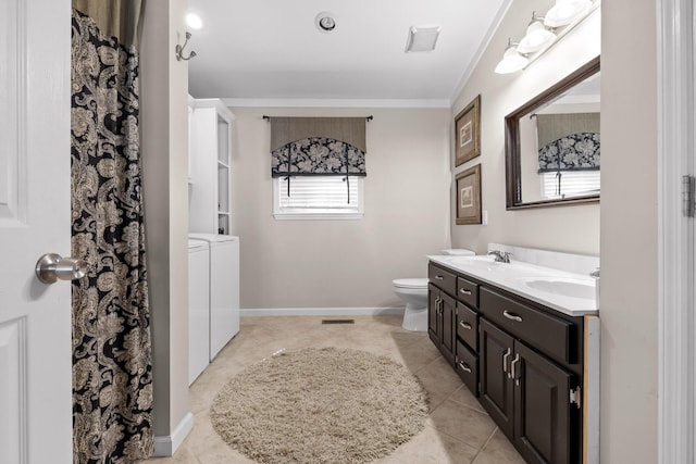 bathroom featuring vanity, tile patterned flooring, washer and dryer, toilet, and ornamental molding