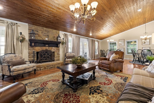 living room featuring french doors, vaulted ceiling, hardwood / wood-style flooring, a fireplace, and wood ceiling