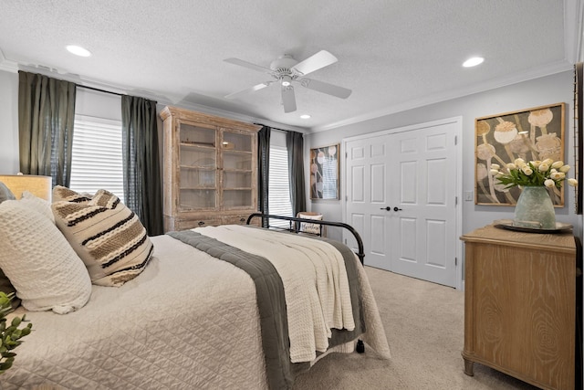 bedroom with multiple windows, a textured ceiling, and ceiling fan