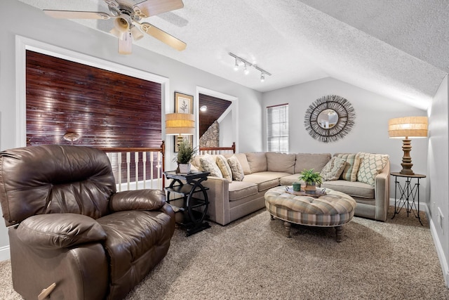 living room with carpet, track lighting, a textured ceiling, vaulted ceiling, and ceiling fan